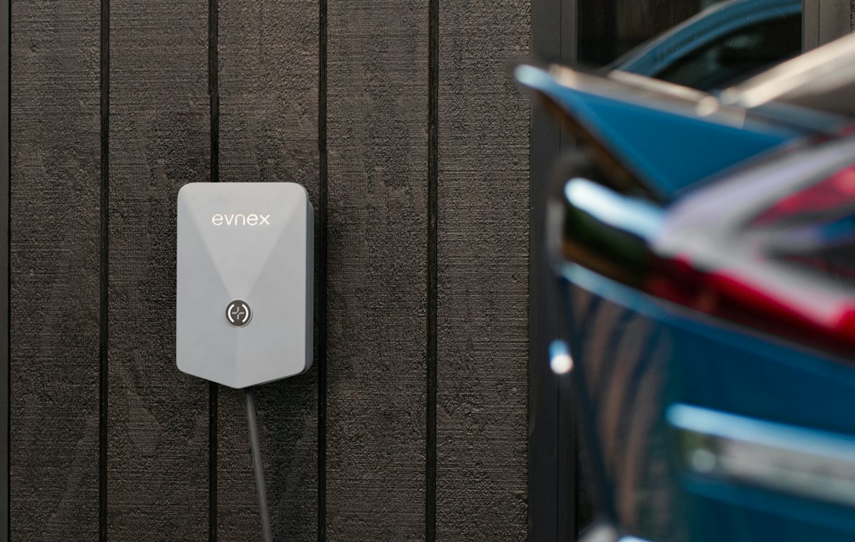 Electric car plugged into a wall-mounted charger